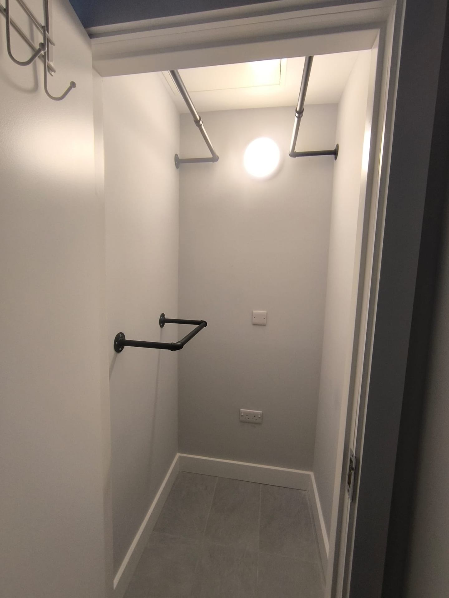 Custom industrial pipe wardrobe rails fitted in a hot press