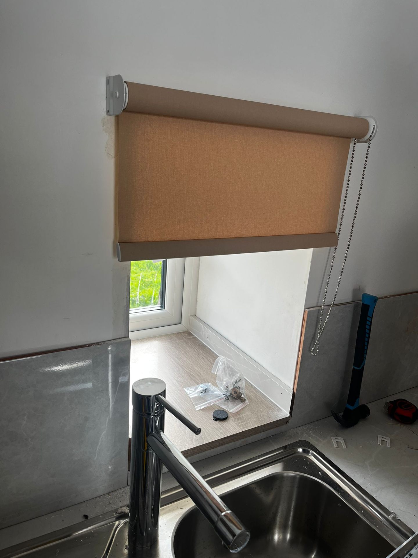 New roller blind installed above a kitchen sink