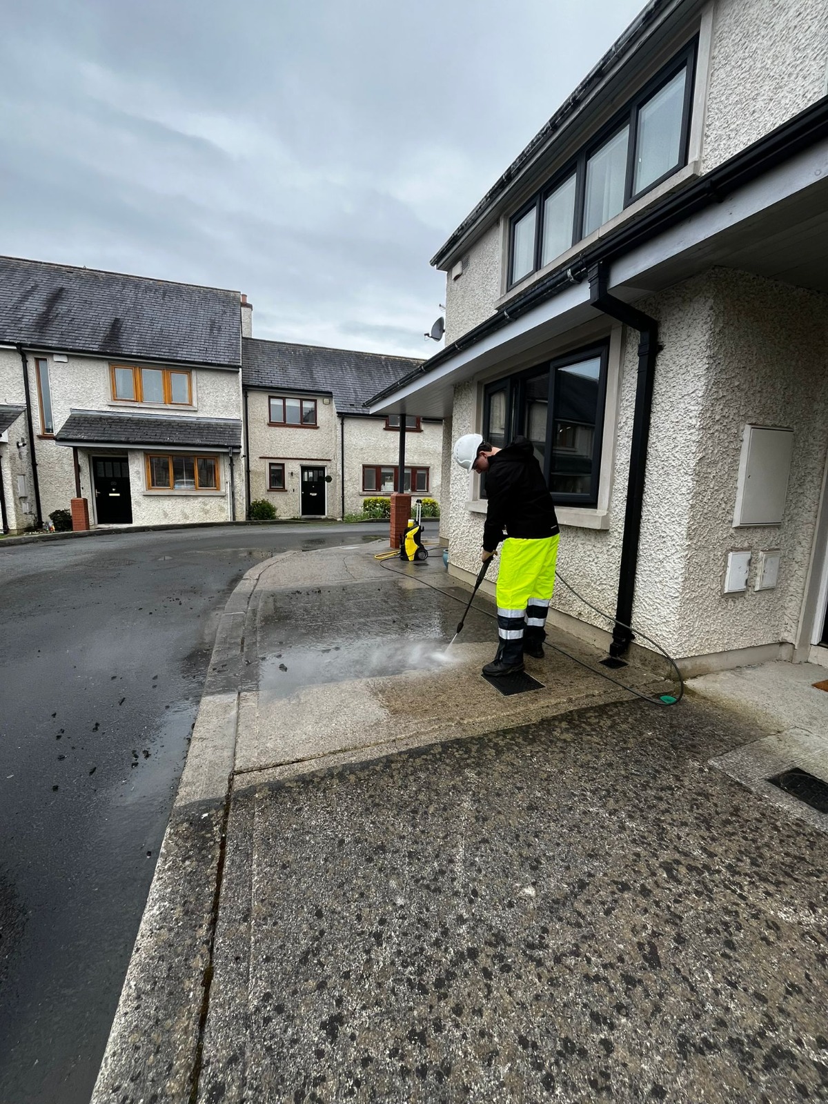 Power washing in progress on a residential driveway
