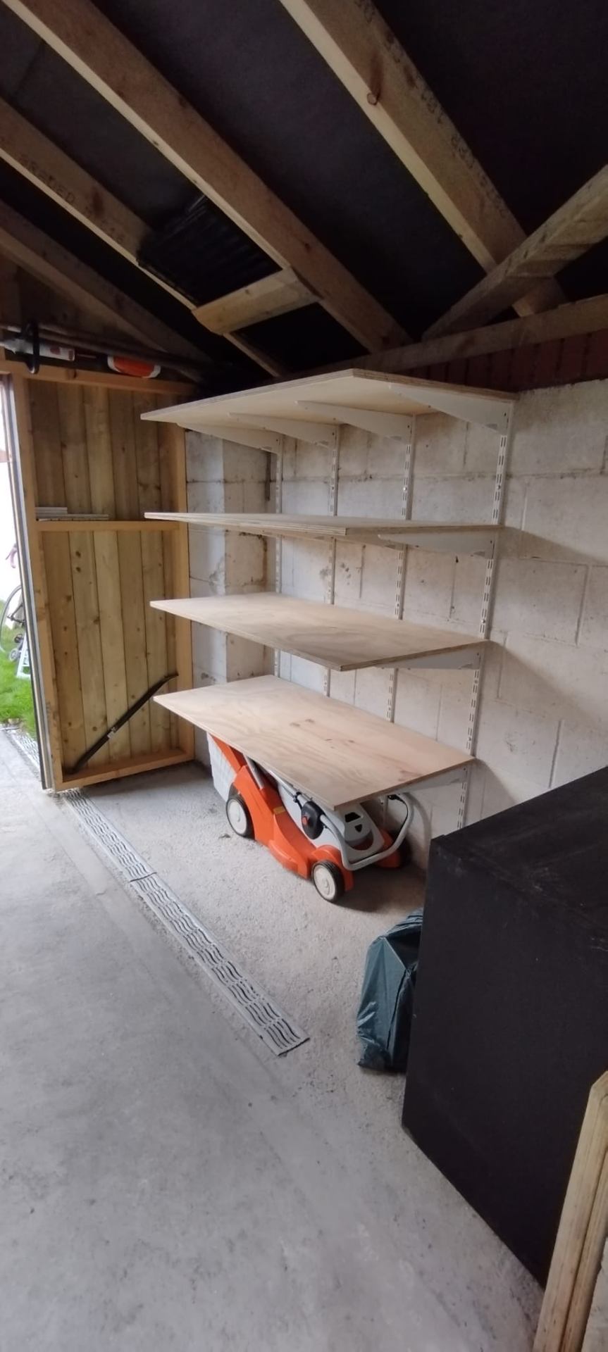 Custom plywood shelving built into a garage
